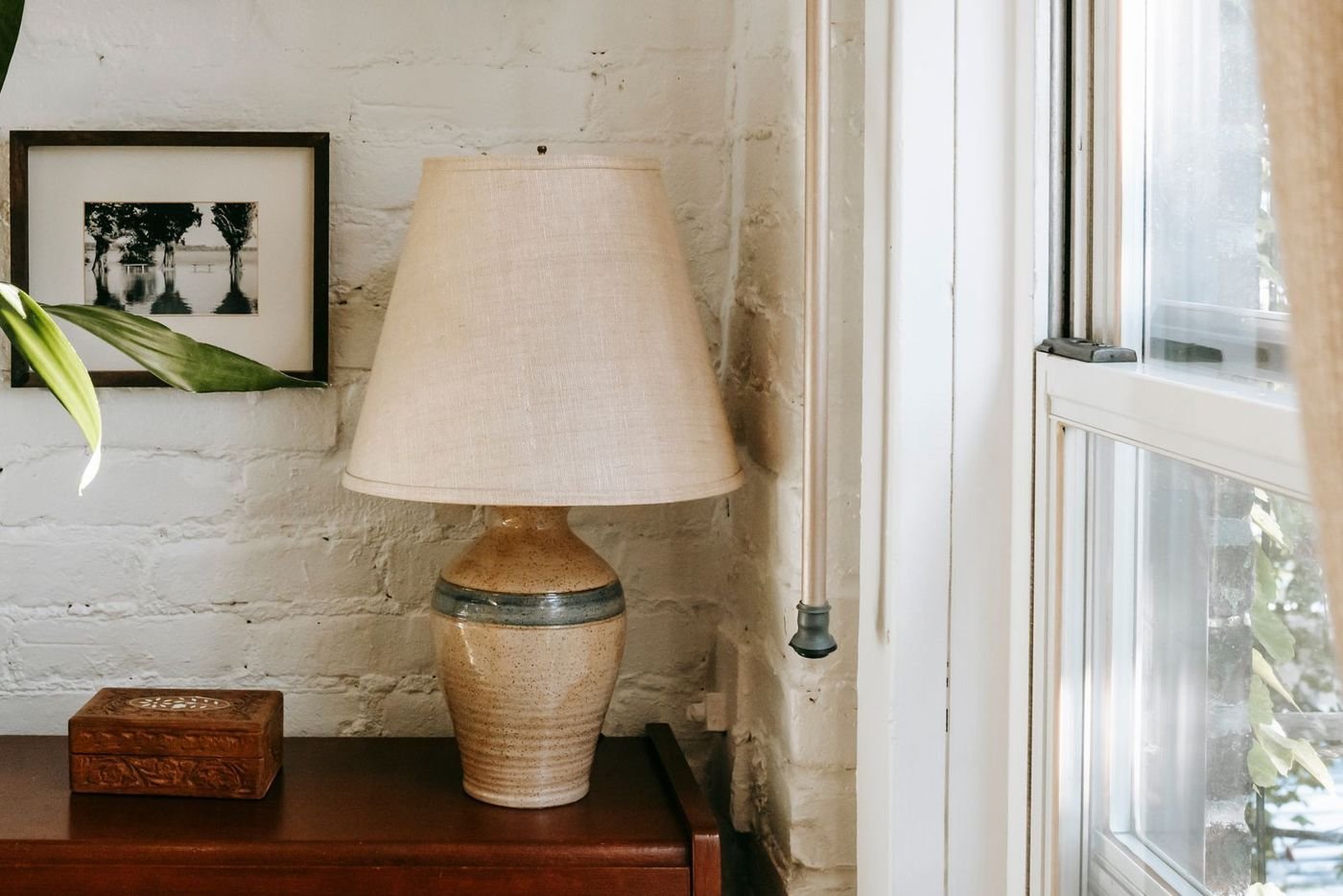 The finished campaign: a ceramic lamp by a sunlit window, ready to publish