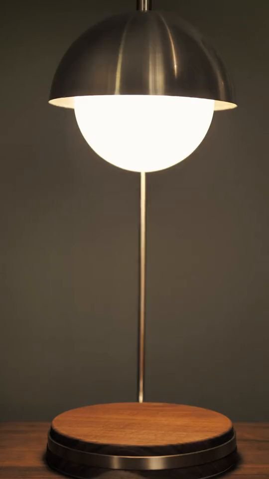 Instagram reel frame: a glowing orb lamp on a walnut base