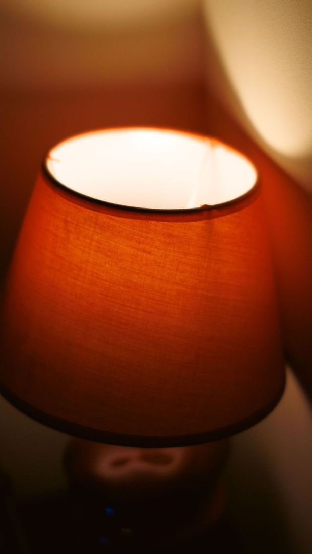 Story frame: close-up of a lamp shade’s warm glow