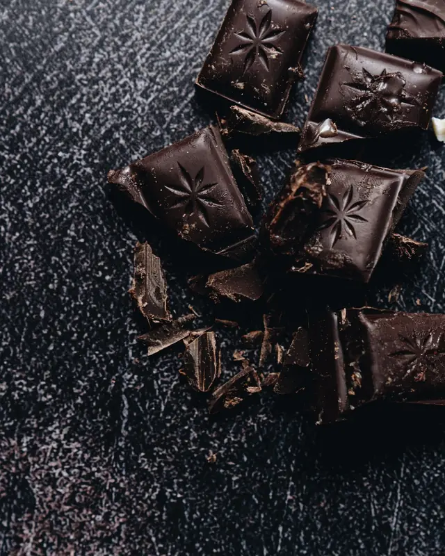 Squares of dark chocolate on grey slate