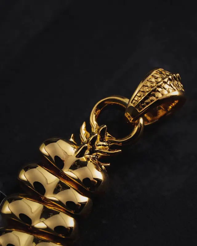 A heavy gold chain in low light