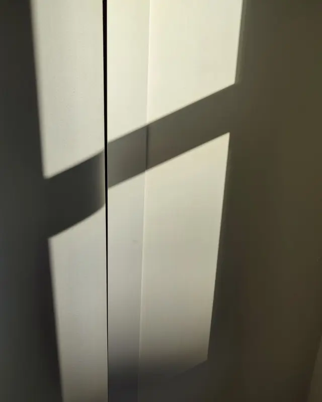 A window of sunlight falling on a pale wall